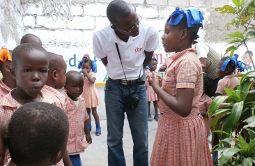 Philiogene at a school with children